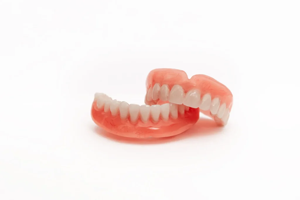 Close-up of natural-looking cosmetic dentures with realistic tooth shading, SnapFit Denture Practice Wolverhampton UK